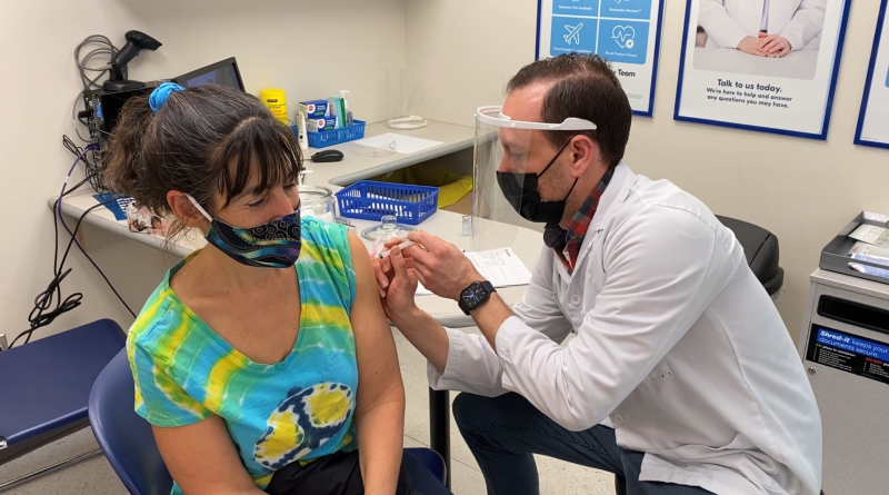 Pharmacist Jordan Clark delivers a COVID-19 vaccine to Melanie Polowin at the Shoppers Drug Mart on Richmond Road in Ottawa. April 3, 2021. (Jeremie Charron / CTV News Ottawa)
