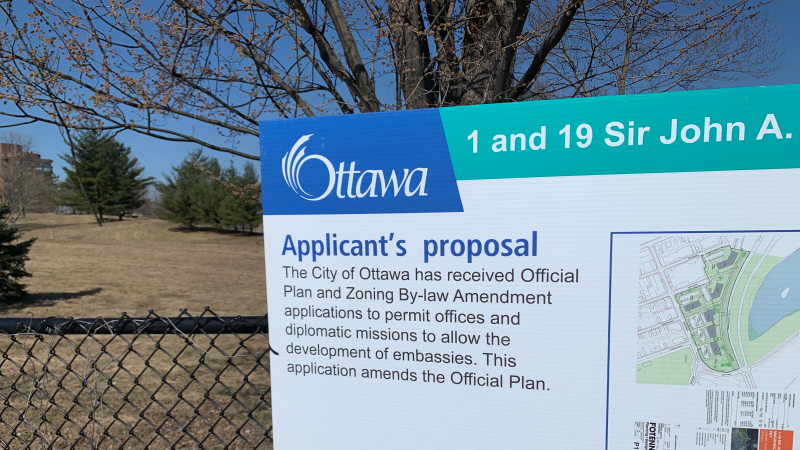 A sign posted outside the lands west of Downtown Ottawa that the National Capital Commission is proposing to turn into a row of embassies. April 5, 2021. (Ian Urbach/CTV News Ottawa)