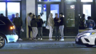 People stand outside MIST Lounge on Whyte Avenue on Sunday evening (CTV News Edmonton).