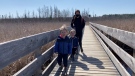 Jeanne Chan with her children Gavin and Blake, are discovering nature along the Mer Bleue Bog boardwalk, part of the NCC Greenbelt trail system. Ottawa, On. Apr. 5, 2020. (Tyler Fleming / CTV News Ottawa)