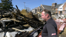 Jason Higginson looking over the remains of a building destroyed by fire in Spencerville, Ont. (Nate Vandermeer / CTV News Ottawa)