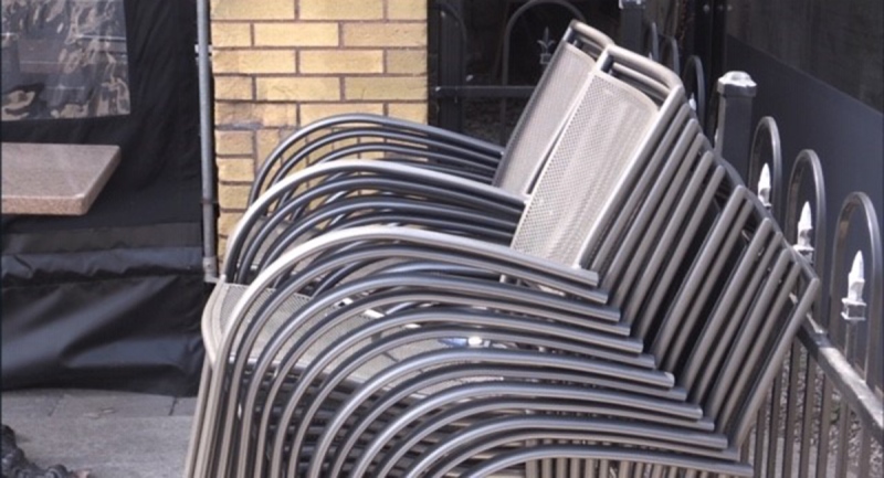 Chairs are stacked on an empty London, Ont. patio on Wednesday, April 7, 2021. (Daryl Newcombe / CTV News)