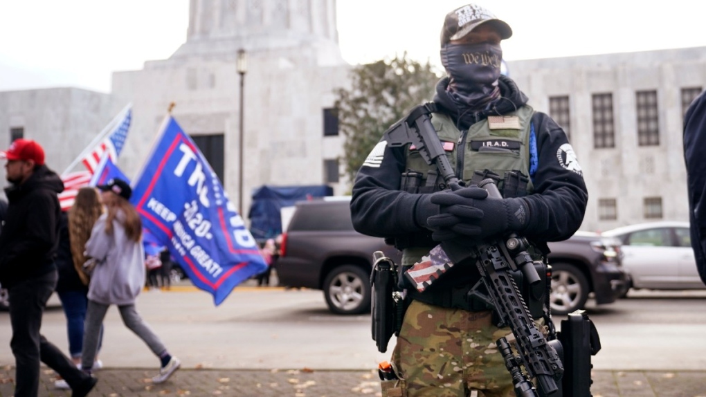 A man holds a gun at the Oregon State Capitol