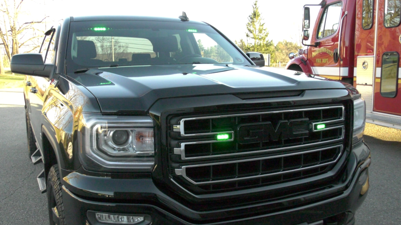A pick-up truck decked out with green flashing lights for volunteer firefighters. (Nate Vandermeer/CTV News Ottawa)