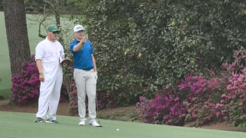 Jace Walker (L) and Mackenzie Hughes ( R) discuss a shot at on the par 5 13th at the Masters Thursday, Apr 8.  (Source: TSN/PGA)


