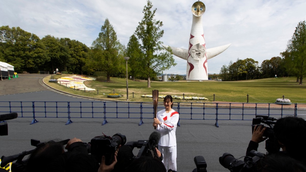 Former Olympian Aya Terakawa poses with the torch