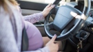 This stock image shows a pregnant woman driving a vehicle. (The University of British Columbia Okanagan campus)