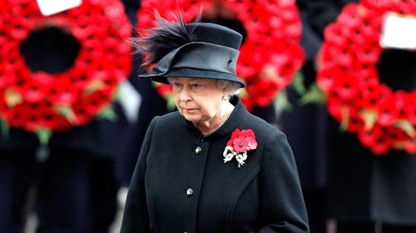 Queen Elizabeth II stands in front of poppy wreaths at the annual Remembrance Sunday ceremony at the cenotaph in London, on Sunday, Nov. 8, 2009. (AP / Kirsty Wigglesworth)