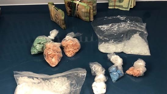 Various drugs and Canadian and U.S. cash seized in Chatham drug bust. (courtesy Chatham-Kent police)