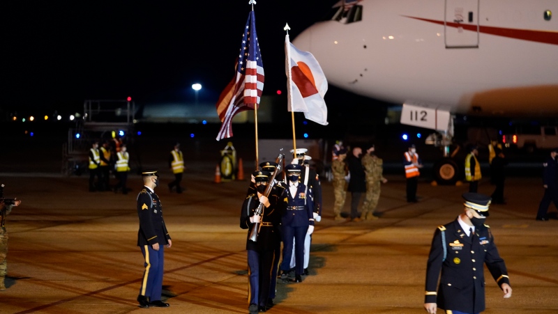 U.S. Armed Services Honor Guard moves into position as then-Japanese Prime Minister Yoshihide Suga arrives at Andrews Air Force Base, Md., Thursday, April 15, 2021. (AP Photo/Manuel Balce Ceneta)