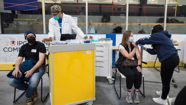 COVID-19 vaccine recipients are photographed at the Downsview Arena vaccination site, in Toronto, Friday, April 16, 2021. THE CANADIAN PRESS/Tijana Martin