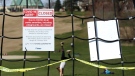 A girl tries a handstand in a Toronto park near a playground closed due to the COVID-19 pandemic on Monday, April 6, 2020. THE CANADIAN PRESS/Colin Perkel