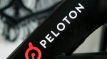 This Nov. 19, 2019 file photo shows a Peloton logo on the company's stationary bicycle in San Francisco. (AP Photo/Jeff Chiu, File)