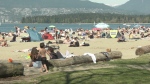 People gather at a Vancouver beach on a sunny April weekend in 2021.