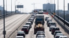 Vehicles entering Ontario from Quebec cross an interprovincial bridge on Monday April 19, 2021 in Ottawa. (Adrian Wyld/THE CANADIAN PRESS)