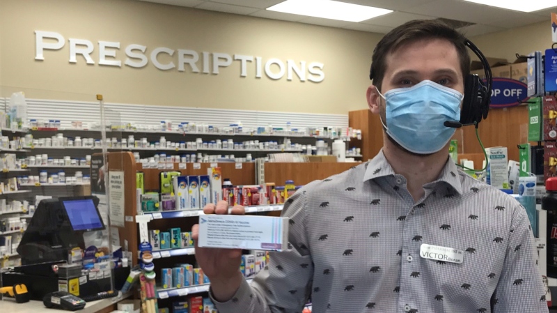 Victor Boran, owner and pharmacist at Bellwood Pharmacy on Oxford Street East in London, Ont. holds a box of Astra-Zeneca COVID-19 vaccine on Monday, April 19, 2021. (Sean Irvine / CTV News)