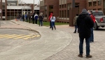People line up outside the Dollard-des-Ormeaux Civic Centre on Wednesday, April 21, 2021 to get vaccinated against COVID-19. (Kelly Grieg/CTV News)