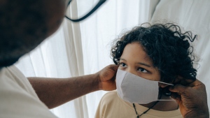 A child wearing a mask is seen in this file image. (Pexels) 