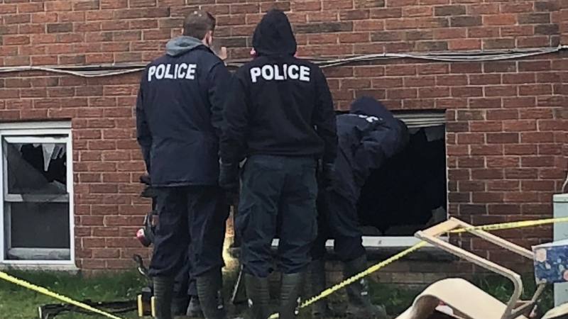Investigators work at the scene of an apartment fire on King Edward Avenue in London, Ont. on Thursday, April 22, 2021. (Jim Knight / CTV News)