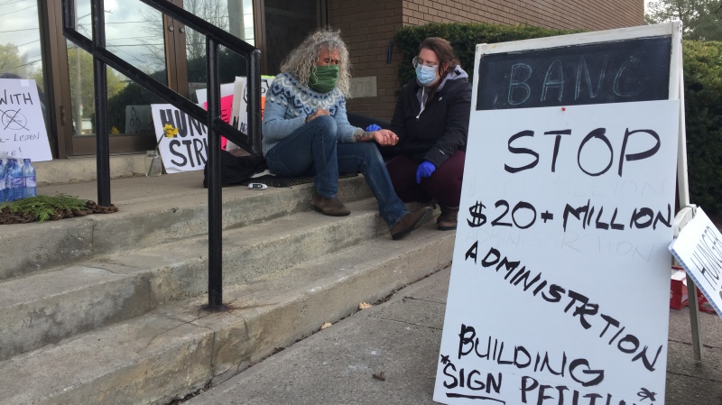 A volunteer nurse tends to Joe Feiner during his hunger strike on the steps of town hall in Alliston, Ont.  Thurs. April 22, 2021 (Roger Klein/CTV News)