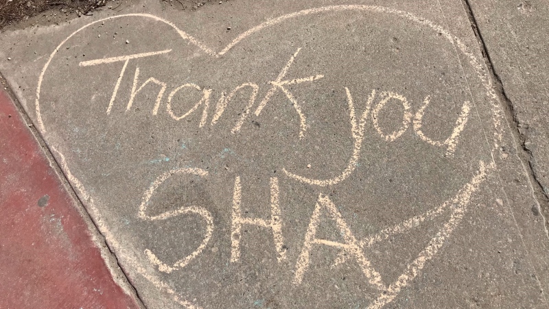 Community members wrote encouraging messages on the sidewalk near the Regina General Hospital after anti-pandemic protests at the hospital earlier this week. (Stefanie Davis/CTV Regina)