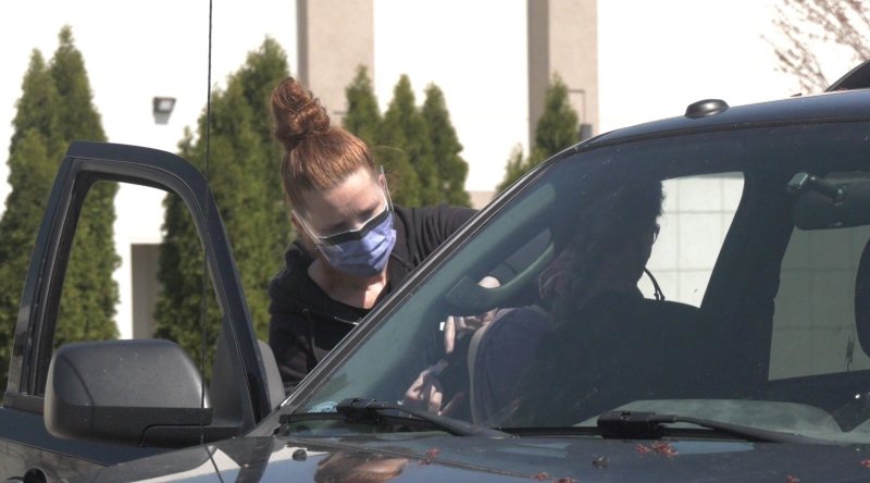 A passenger gets their COVID-19 vaccine at a drive-thru clinic at the Metropolitan Bible Church in Ottawa on Saturday, (Colton Praill/CTV News Ottawa)