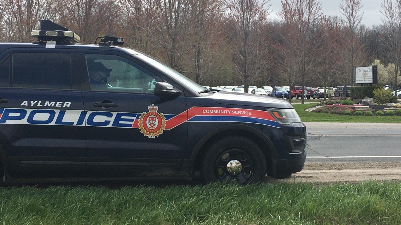 Aylmer, Ont. police sit outside of the Church of God as a large service takes place indoors on April 25, 2021. (Brent Lale/CTV London)