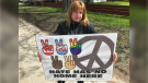 Laura Hasulo holds up one of the lawn signs for her “hate has no home here” movement in Essex County, Ont. on Sunday, April 25, 2021. (Michelle Maluske/CTV Windsor)