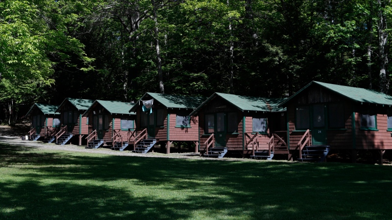 In this file photo from June 4, 2020 photo, a row of cabins can be seen at Camp Winnebago summer camp in Fayette, Maine. (AP Photo/Robert F. Bukaty)
