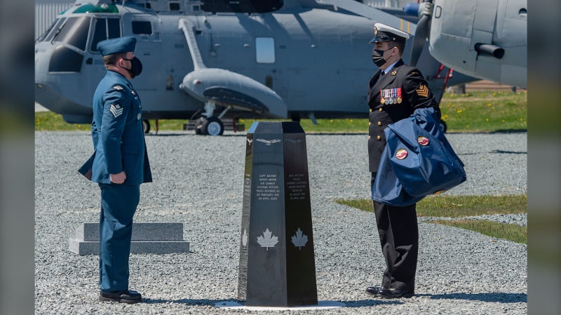 A sailor and an aviator observe a moment of silence after unveiling a memorial at 12 Wing Shearwater in Dartmouth, N.S. on the first anniversary of a CH-148 Cyclone helicopter crash that claimed the lives of six Canadian Forces members when the aircraft plunged into the ocean, on Thursday, April 29, 2021. THE CANADIAN PRESS/Andrew Vaughan