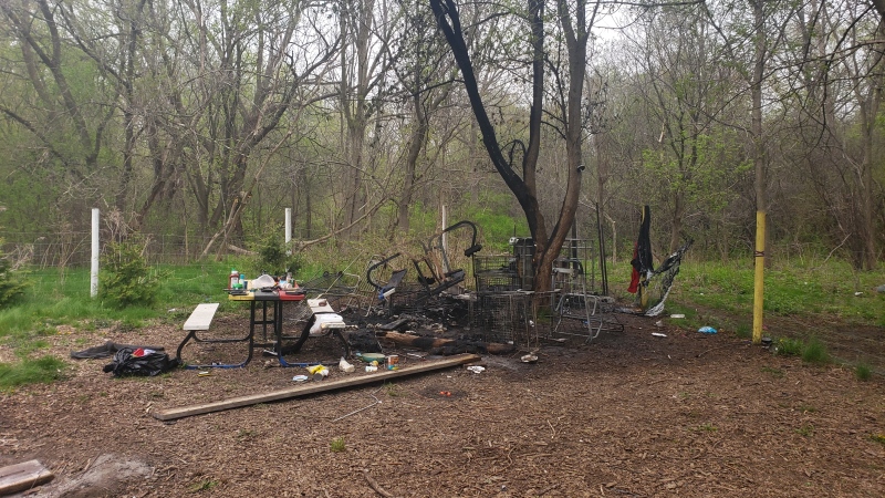 Homeless camp fire near the Thames River in London, Ont. on April 29, 2021. (Ian MacLean)