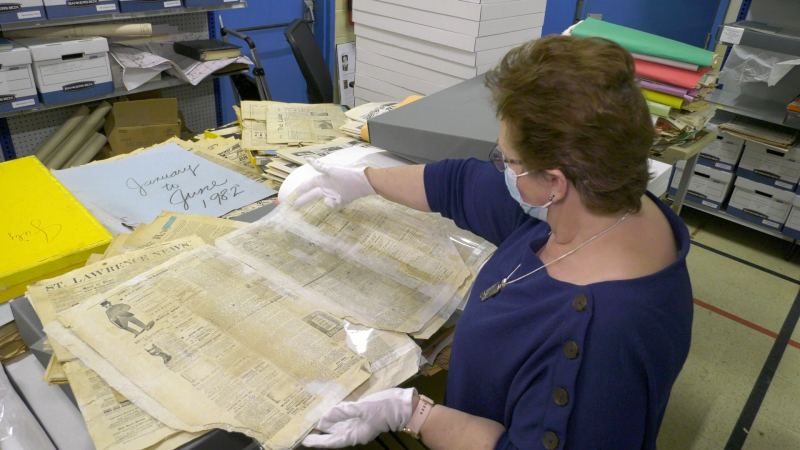 Dundas county archivist Susan Peters looking over an old newspaper. (Nate Vandermeer/CTV News Ottawa)