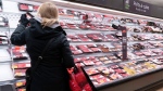 A customer shops at a meat counter in a grocery store in Montreal, on Thursday, April 30, 2020. THE CANADIAN PRESS/Paul Chiasson