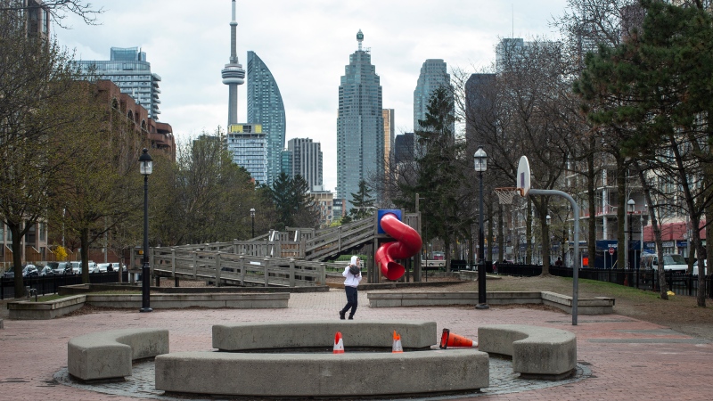A youth plays basketball in an otherwise quiet court in Toronto. Public health experts are raising their eyebrows at Ontario's decision to restrict outdoor gatherings, saying the latest evidence suggests the measures won't do much to cut down on COVID-19 transmission. THE CANADIAN PRESS/Chris Young