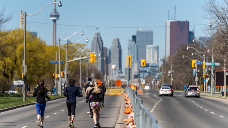 A group of runners run along Lake Shore Blvd. East as road closures come into effect for the return of the ActiveTO program in Toronto on Saturday, May 1, 2021.THE CANADIAN PRESS/Yader Guzman
