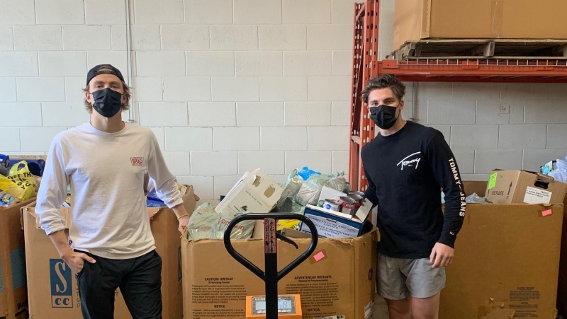 Wilson O’Neill and Michael Boushy stand in front of one large bin of food, just one of two they’ve donated so far, to the London Food Bank. (Submitted Photo)