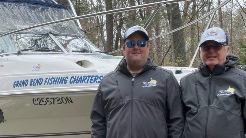 Ryan and Rob Sharpe stand in front of their boat (Source: Ryan Sharpe)
