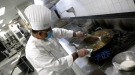 A chef At St. Clair College in Windsor, Ont. whips up a batch of stir fry on April 29, 2021. (Rich Garton / CTV Windsor)