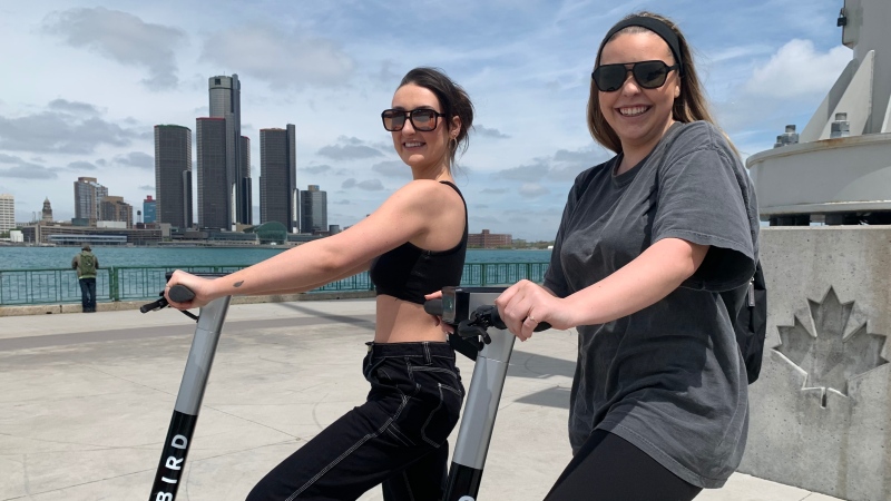 Abigail Radlin and Elise Trepanier take a spin around the Windsor side of the Detroit Riverfront on Bird e-scooters on May 4, 2021. (Rich Garton/CTV Windsor)