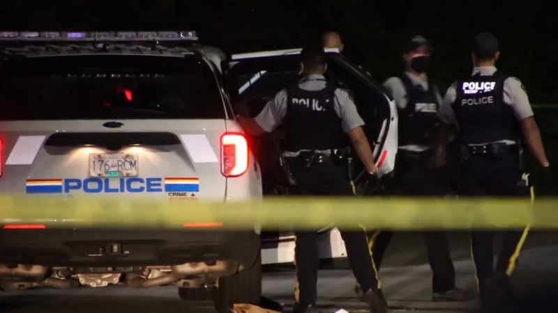RCMP officers respond to a shooting in Surrey, B.C., that left a woman fatally injured on May 4, 2021. 