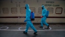 Health workers in personal protective equipment sanitize a train prepared as COVID-19 care centre in the wake of spike in the number of positive coronavirus cases, at a railway station in Gauhati, India, Thursday, May 6, 2021. (AP Photo/Anupam Nath)