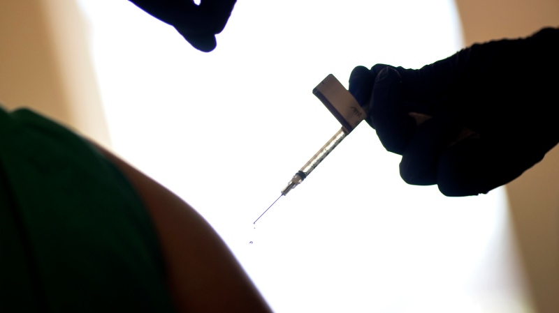FILE - In this Tuesday, Dec. 15, 2020, file photo, a droplet falls from a syringe after a health care worker was injected with the Pfizer-BioNTech COVID-19 vaccine at a hospital in Providence, R.I. (AP Photo/David Goldman, File)