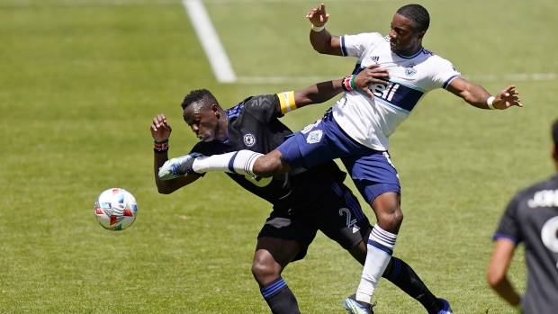 CF Montréal midfielder Victor Wanyama (2) and Vancouver Whitecaps forward Cristian Dajome, right, battle for the ball in the first half of an MLS soccer game Saturday, May 8, 2021, in Sandy, Utah. (AP Photo/Rick Bowmer)