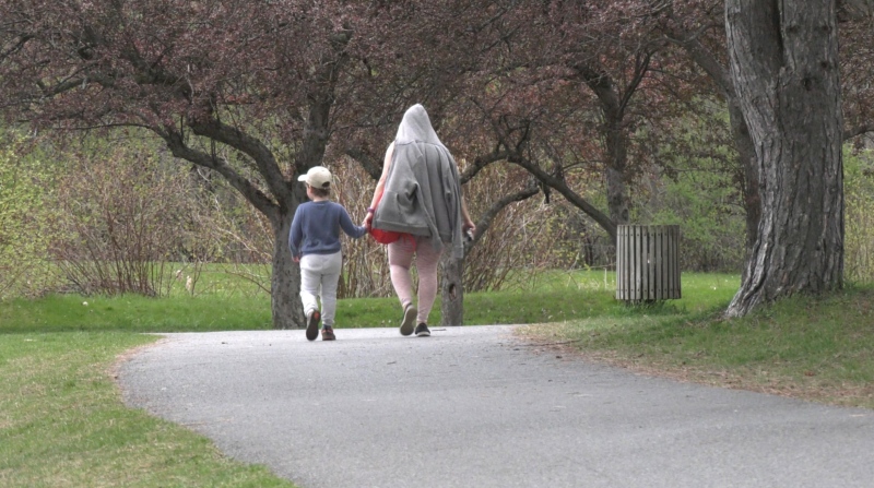 A mother and son go for a walk in Andrew Hayden Park on Mother's Day. (Colton Praill/CTV News Ottawa)