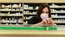 Pharmacist Barbara Violo arranges all the empty vials of the Oxford-AstraZeneca COVID-19 vaccines that she has provided to customers at the Junction Chemist which is a independent pharmacy during the COVID-19 pandemic in Toronto, on Monday, April 19, 2021. THE CANADIAN PRESS/Nathan Denette