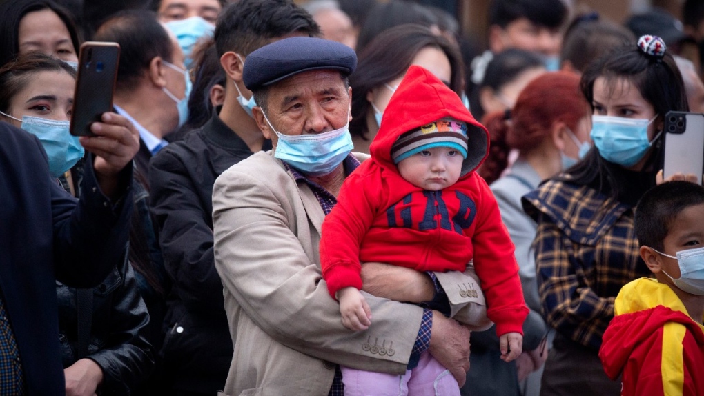 A man holds a child in Urumqi, Xinjiang