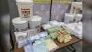 Some of the drugs and cash seized by ALERT, including 113.5 litres of GHB, which police say this is the largest ever seizure in Alberta. (ALERT handout)