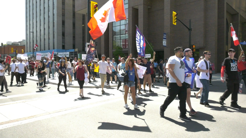 A crowd marches through downtown Ottawa in protest of Ontario's stay-at-home order and other COVID-19 restrictions. May 15, 2021. (Shaun Vardon / CTV News Ottawa)