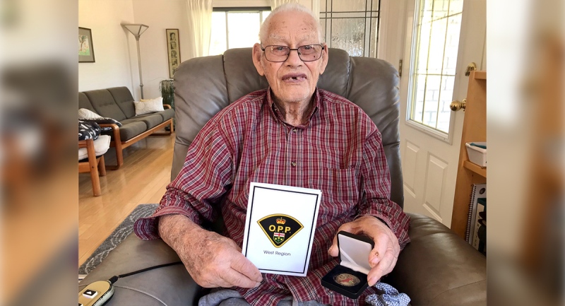 Ed Butler of Lucan, Ont. holds the Regional Commanders Coin given to him in honour of his late grandfather Peter Butler III, who was the first Black officer to serve with the Ontario Provincal Police. (Sean Irvine / CTV News)