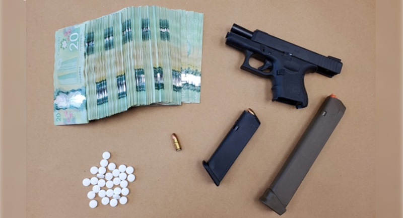 A handgun, drugs and cash seized in London, Ont. on Sunday, May 16, 2021. (Source: London Police Service)